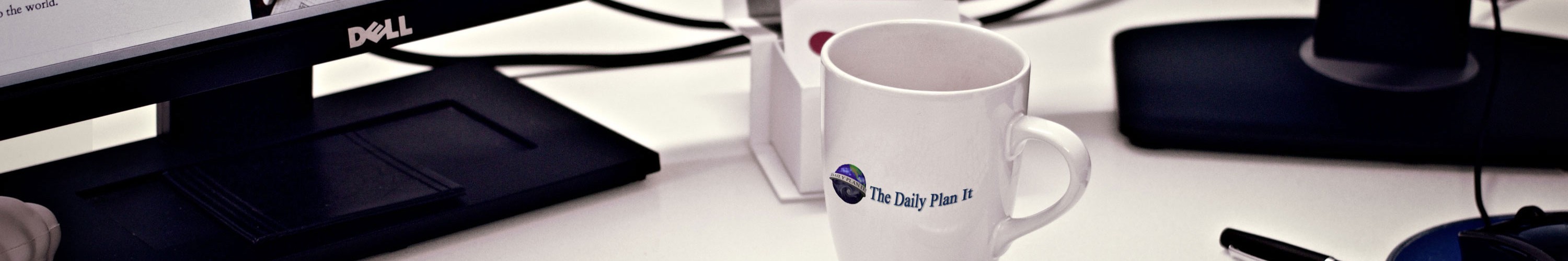 Daily Plan It - Where Your Business is The Center of Our Universe. Desk with coffee mug